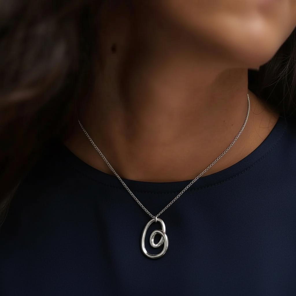 Amara Jewels abstract pendant necklace in sterling silver with intertwined loops design.