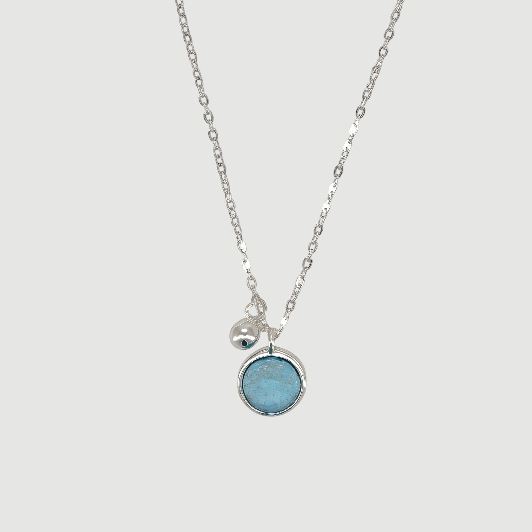 Amara Jewels sterling silver necklace with a round aqua charm and a polished silver bead.