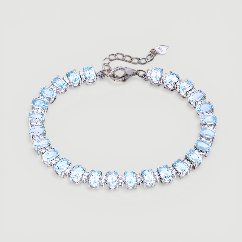 Amara Jewels blue topaz tennis bracelet in 925 sterling silver with adjustable clasp. Oval cut stones.