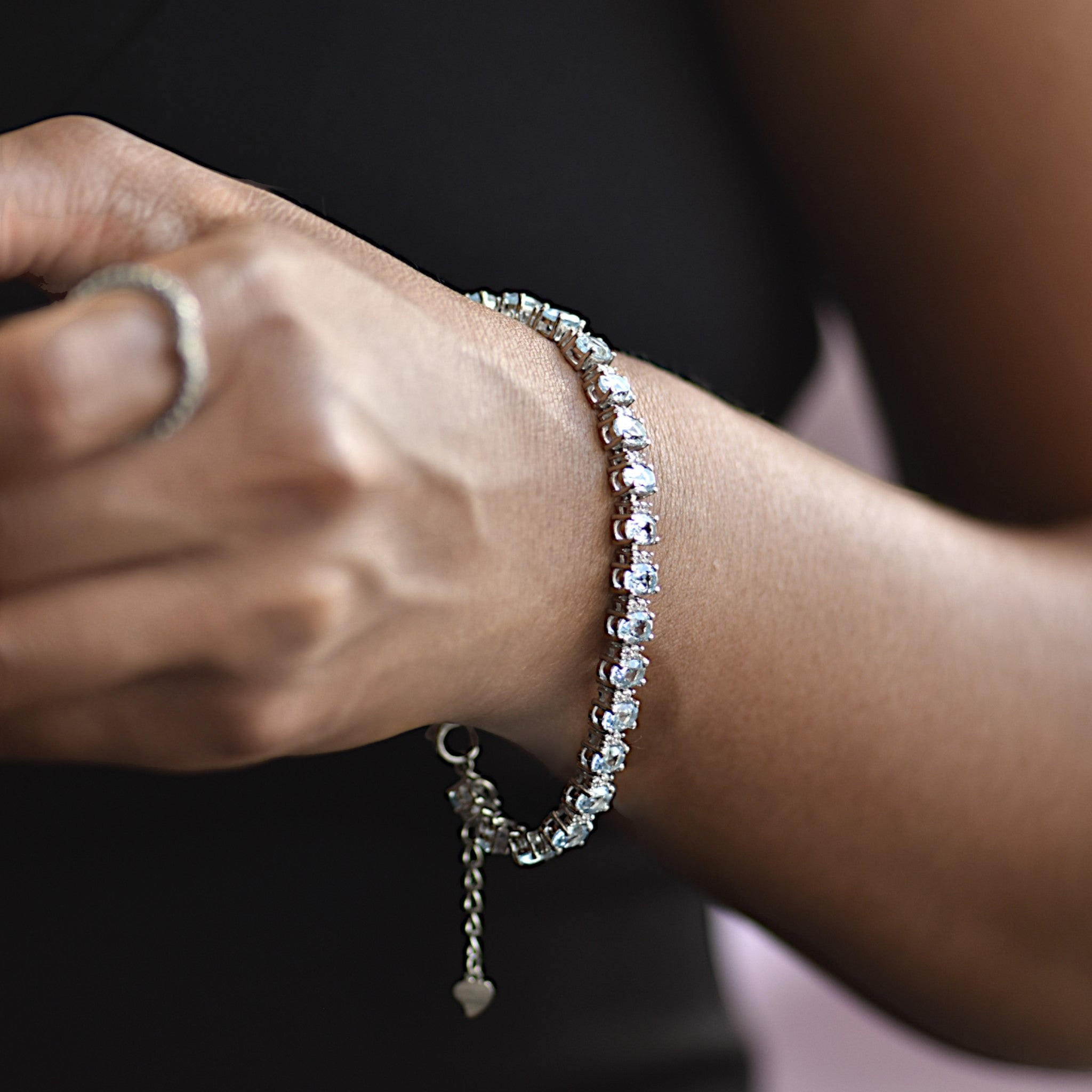Amara Jewels blue topaz tennis bracelet in 925 sterling silver with adjustable clasp. Oval cut stones.