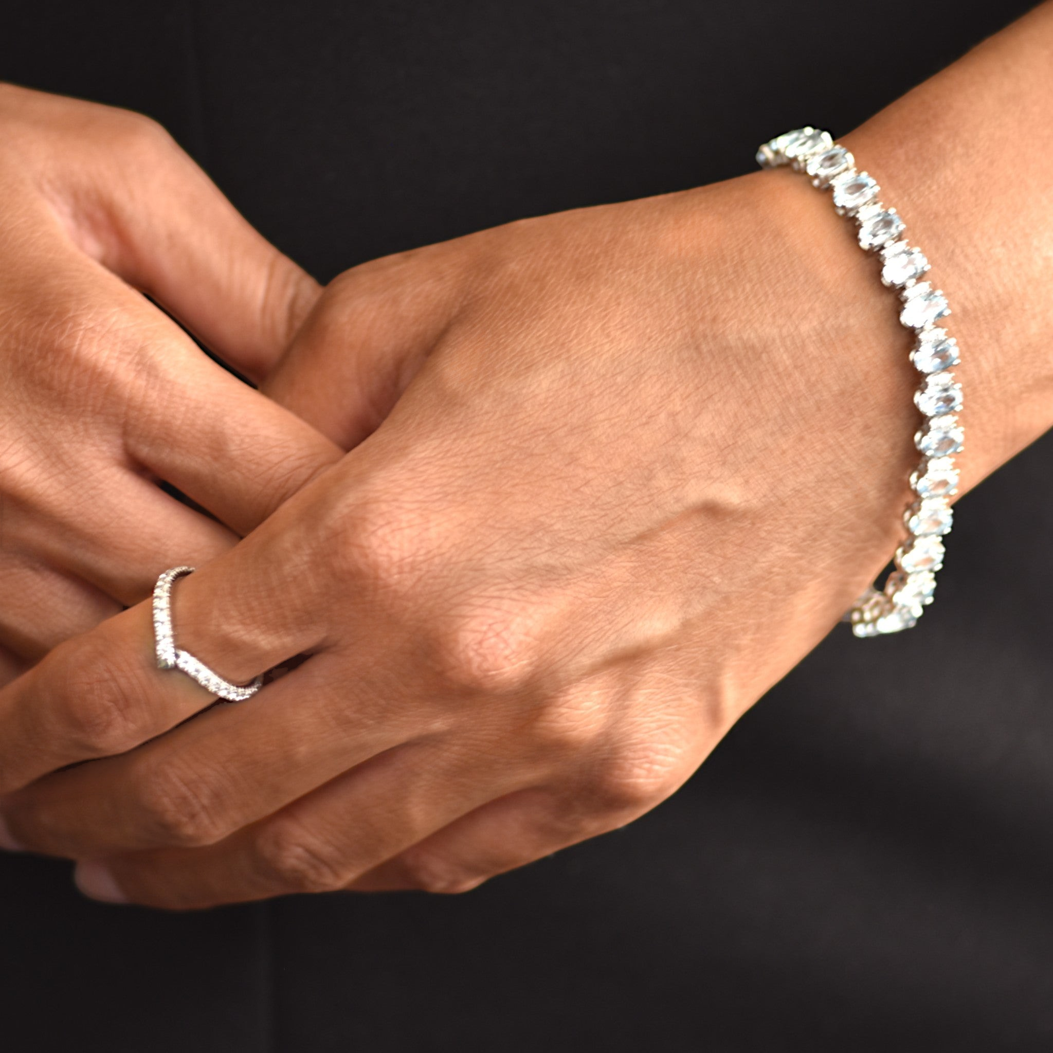 Amara Jewels blue topaz tennis bracelet in 925 sterling silver with adjustable clasp. Oval cut stones.