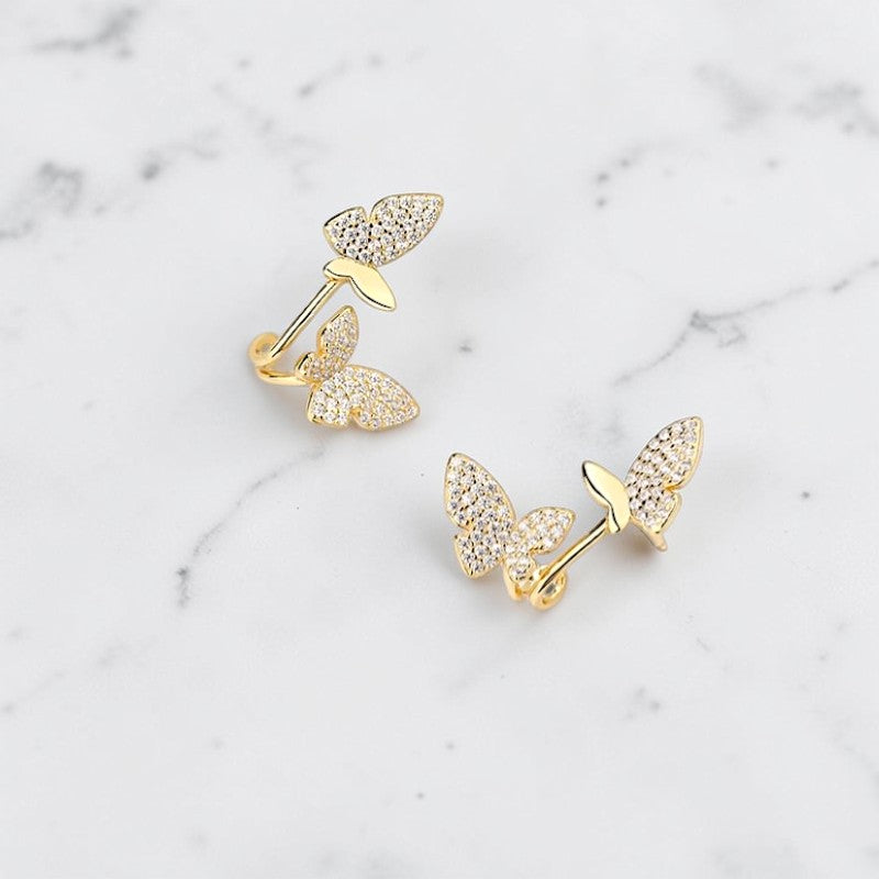 Amara Jewels gold-plated sterling silver climber earrings with cubic zirconia butterflies.