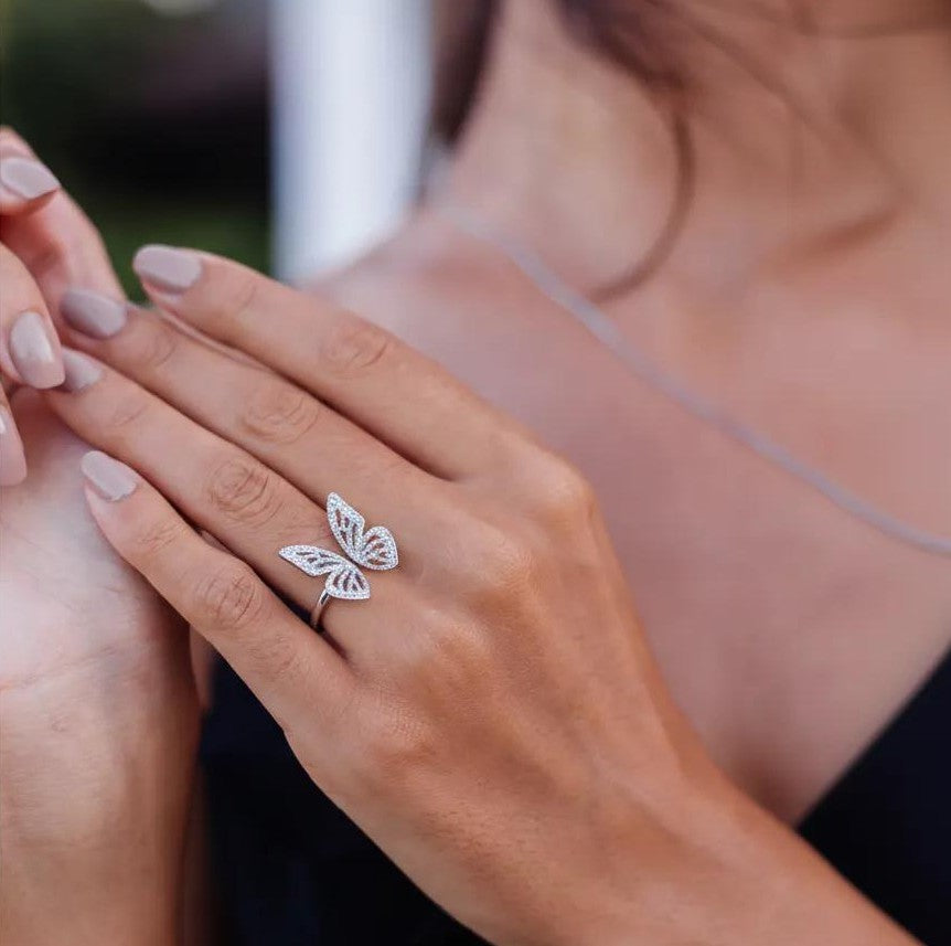 Amara Jewels 925 Sterling Silver open ring with delicate, openwork butterfly wings adorned with small crystals. Adjustable band.