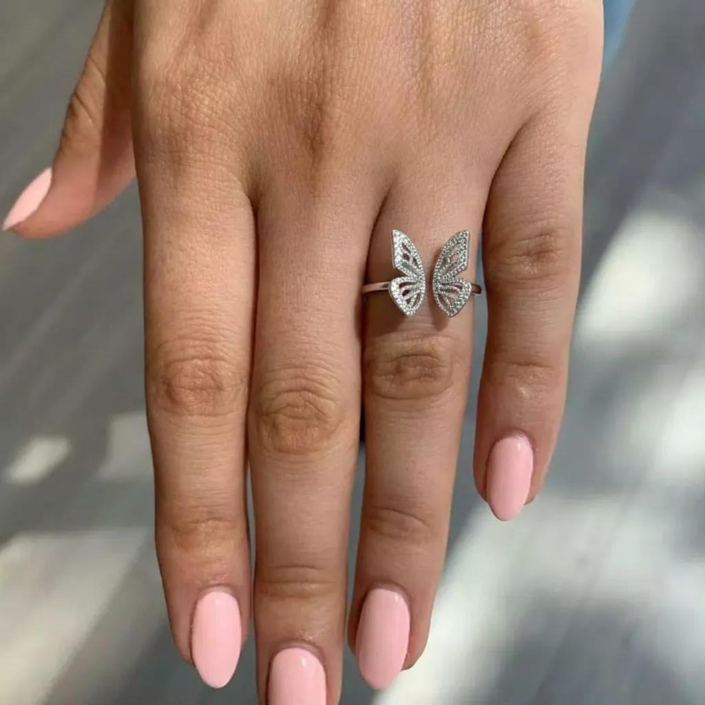 Amara Jewels 925 Sterling Silver open ring with delicate, openwork butterfly wings adorned with small crystals. Adjustable band.