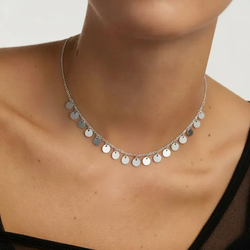 Amara Jewels delicate sterling silver necklace with multiple small disc charms, perfect for everyday wear.