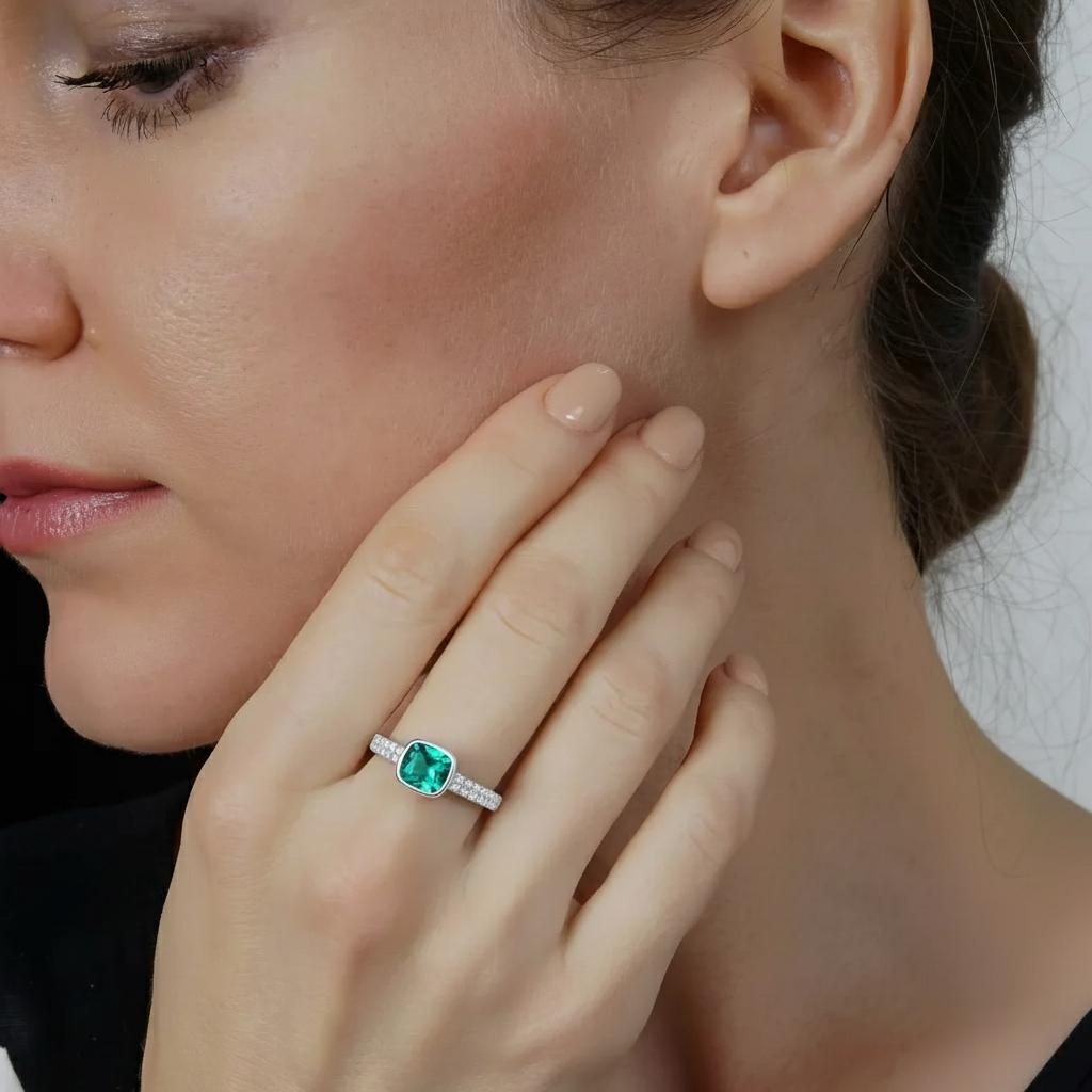 Amara Jewels sterling silver ring with cushion-cut emerald green stone and pave-set crystals.