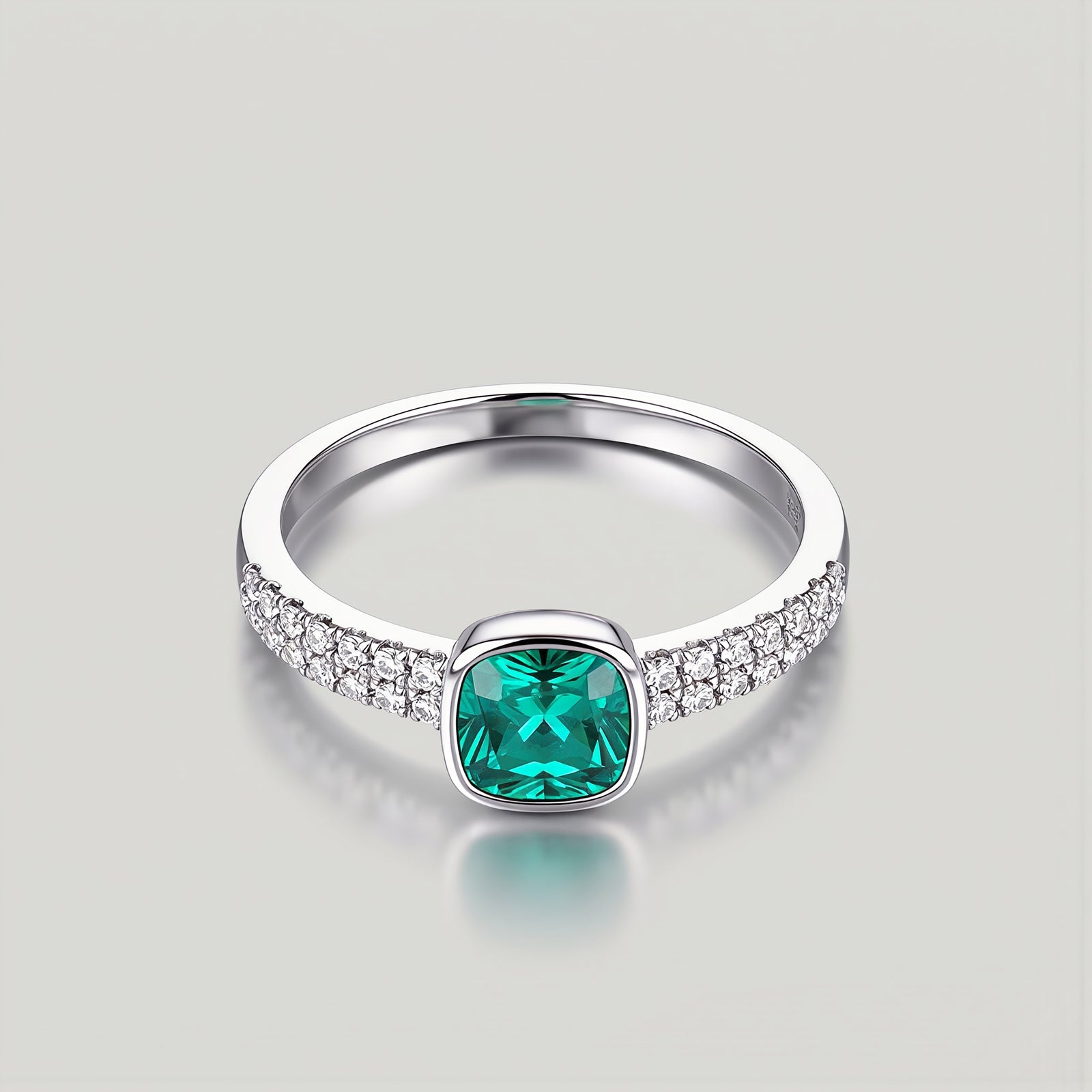 Amara Jewels sterling silver ring with cushion-cut emerald green stone and pave-set crystals.