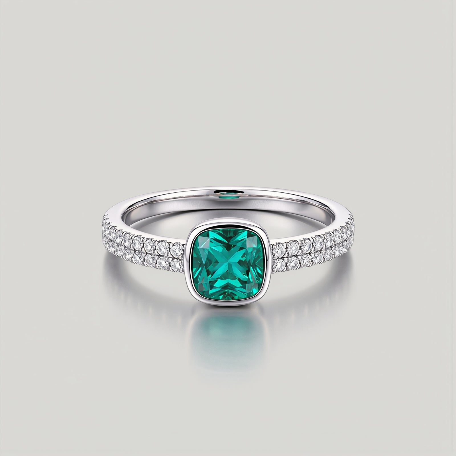 Amara Jewels sterling silver ring with cushion-cut emerald green stone and pave-set crystals.