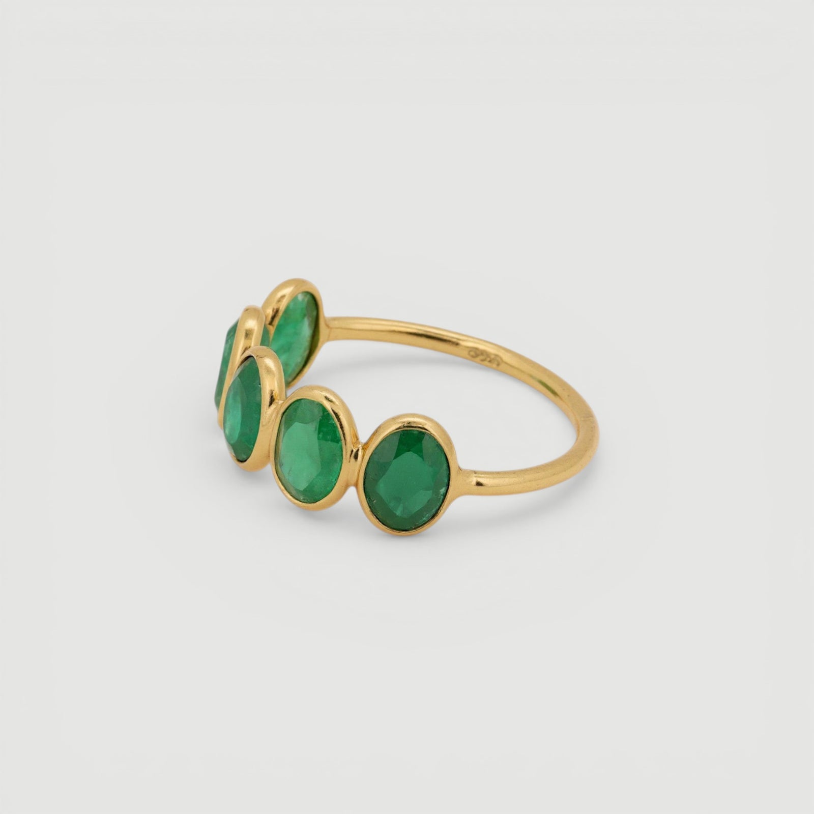 Amara Jewels 18K gold vermeil ring with five oval-cut emeralds set in sterling silver.