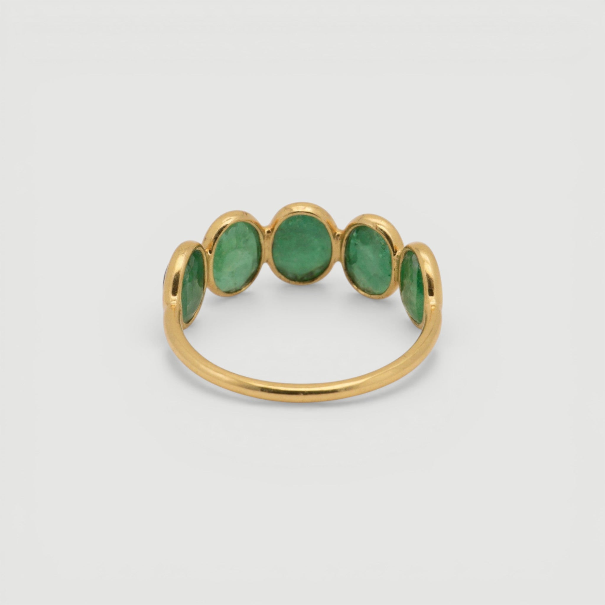 Amara Jewels 18K gold vermeil ring with five oval-cut emeralds set in sterling silver.