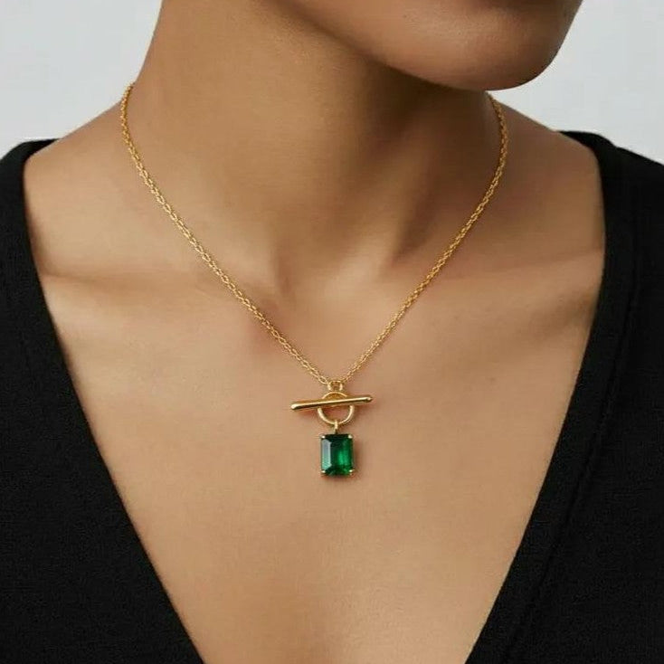 Amara Jewels gold vermeil sterling silver necklace with a rectangular emerald-green gemstone and toggle clasp.