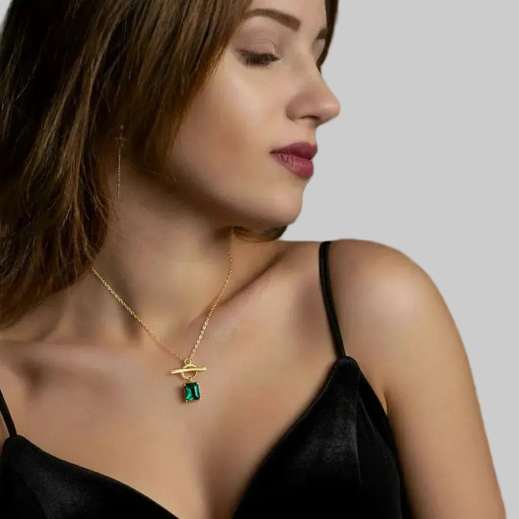 Amara Jewels gold vermeil sterling silver necklace with a rectangular emerald-green gemstone and toggle clasp.