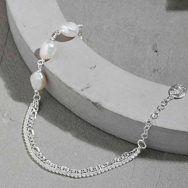 Amara Jewels 925 sterling silver bracelet with freshwater pearls and a dual chain design, one chain is accented with sparkling stones.