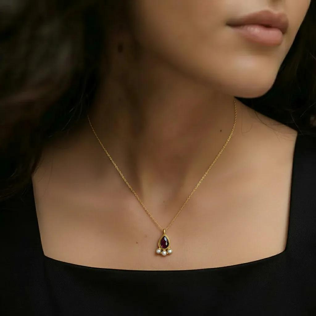 Amara Jewels teardrop necklace with deep red garnet and three pearls, set in 18K gold vermeil over sterling silver.