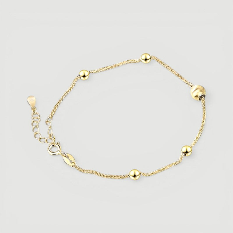 Amara Jewels gold-plated sterling silver bracelet with delicate chain and polished, textured beads.
