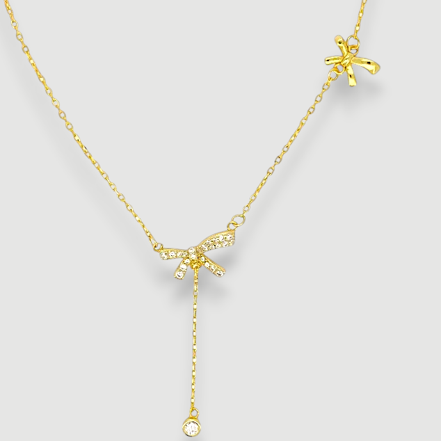Amara Jewels gold-plated sterling silver necklace with bow pendant adorned with cubic zirconia and a crystal dangle.