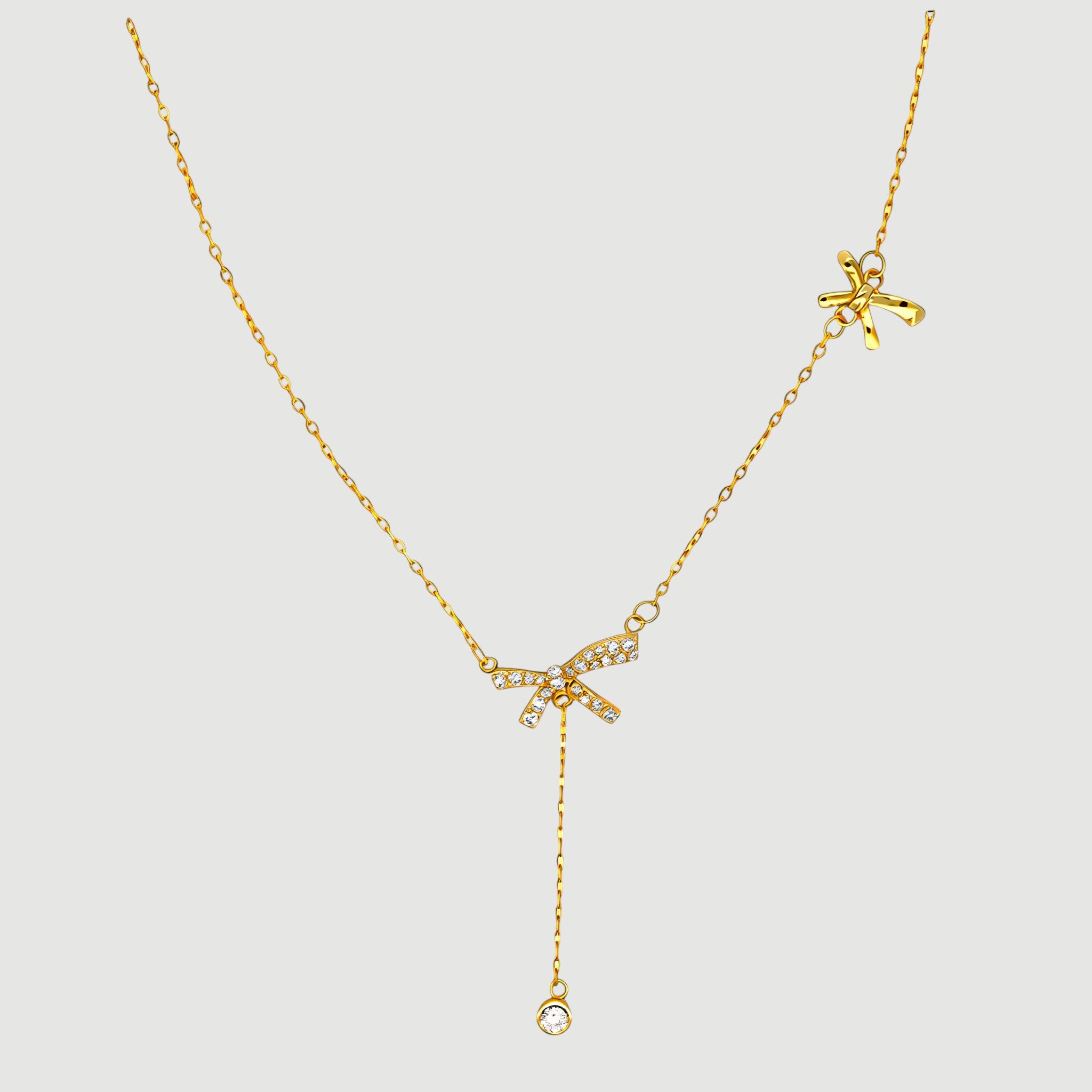 Amara Jewels gold-plated sterling silver necklace with bow pendant adorned with cubic zirconia and a crystal dangle.