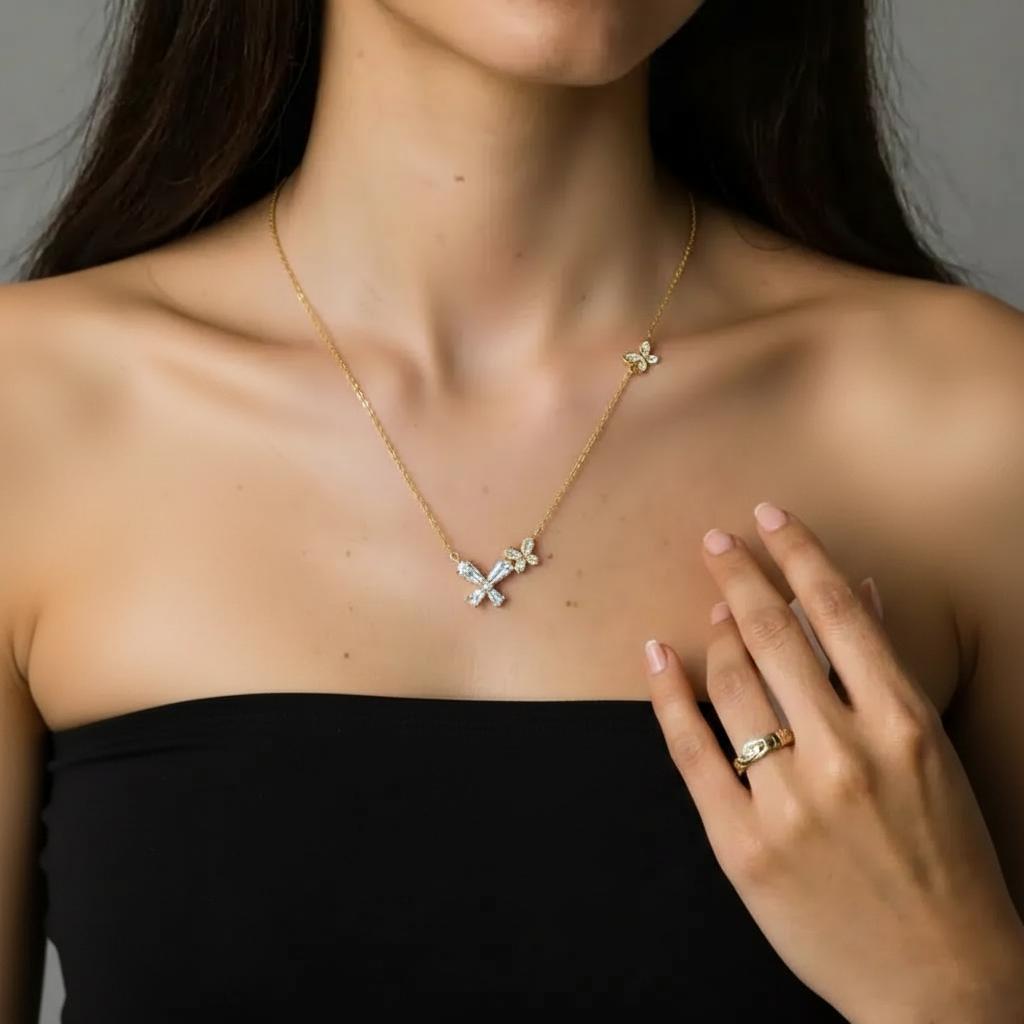 Amara Jewels gold-tone sterling silver necklace with butterfly and floral design, accented with cubic zirconia.