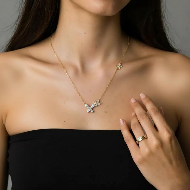 Amara Jewels gold-tone sterling silver necklace with butterfly and floral design, accented with cubic zirconia.