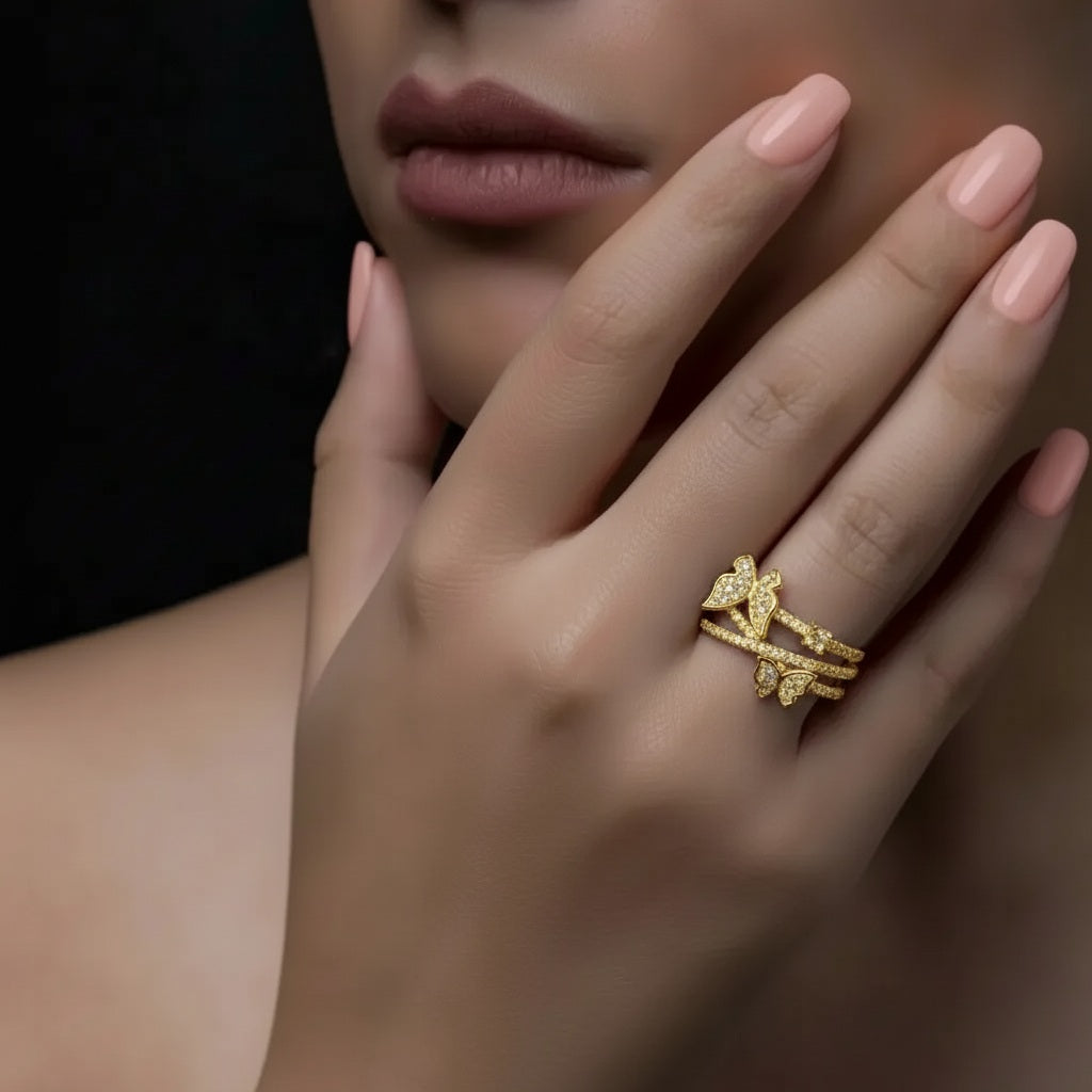 Amara Jewels gold-tone 925 sterling silver ring with cubic zirconia encrusted butterfly and leaf motifs.