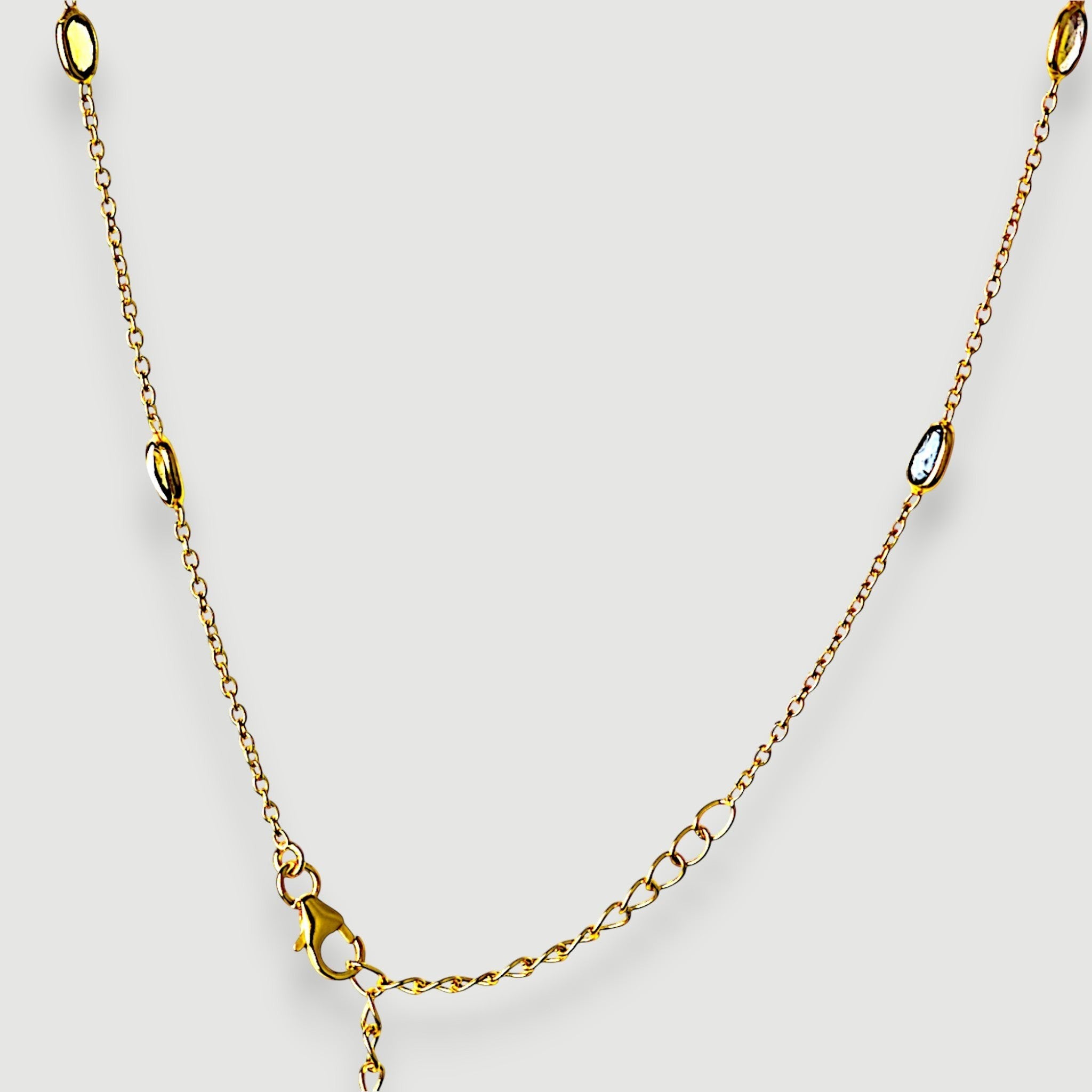 Amara Jewels 18K gold vermeil station necklace with bezel-set pastel amethyst, rose quartz, and green tourmaline.