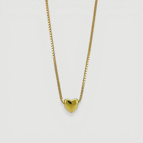 Amara Jewels minimalist gold heart pendant necklace on a delicate box chain. Elegant and simple.