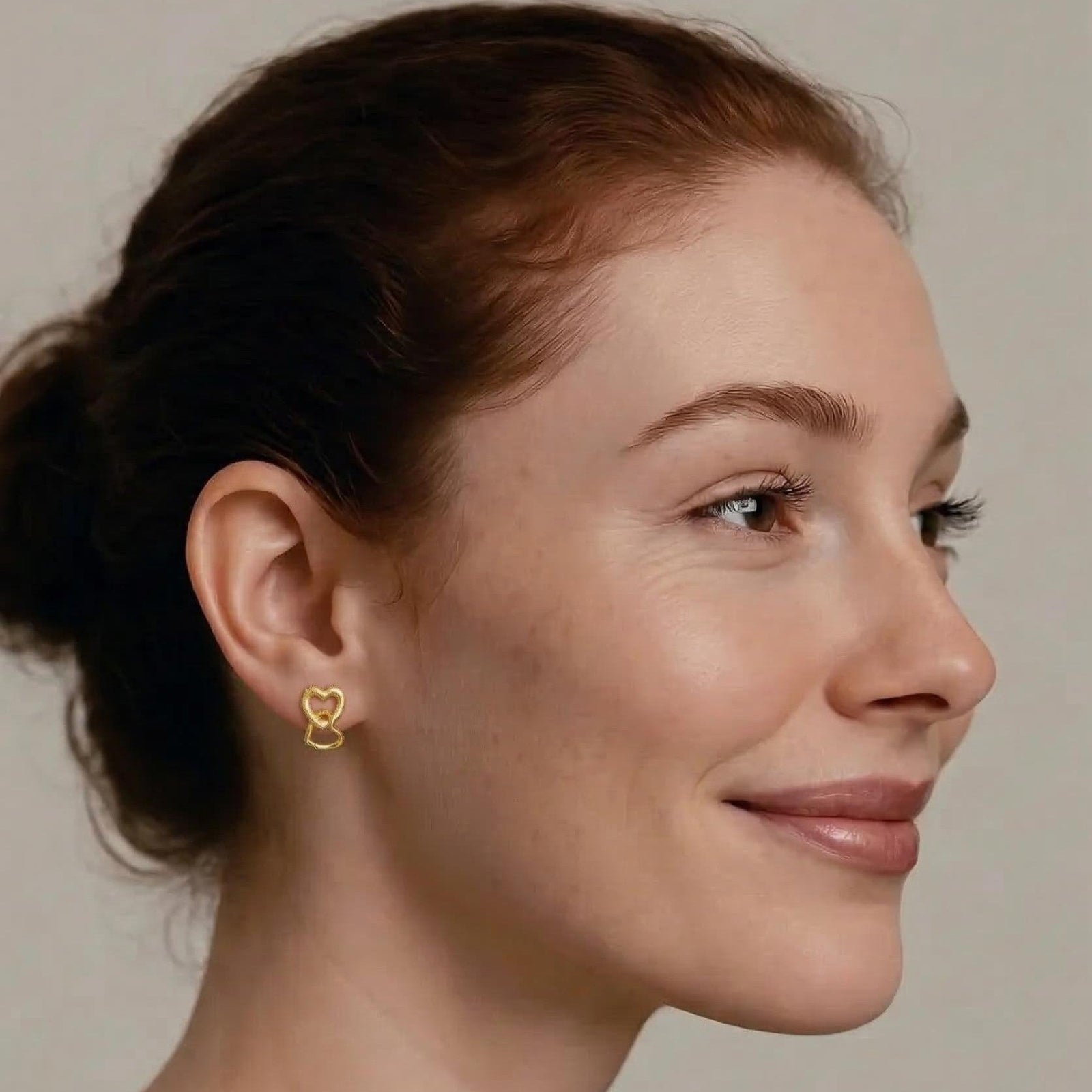 Amara Jewels gold-vermeil sterling silver interlocking heart earrings with textured and polished finishes.