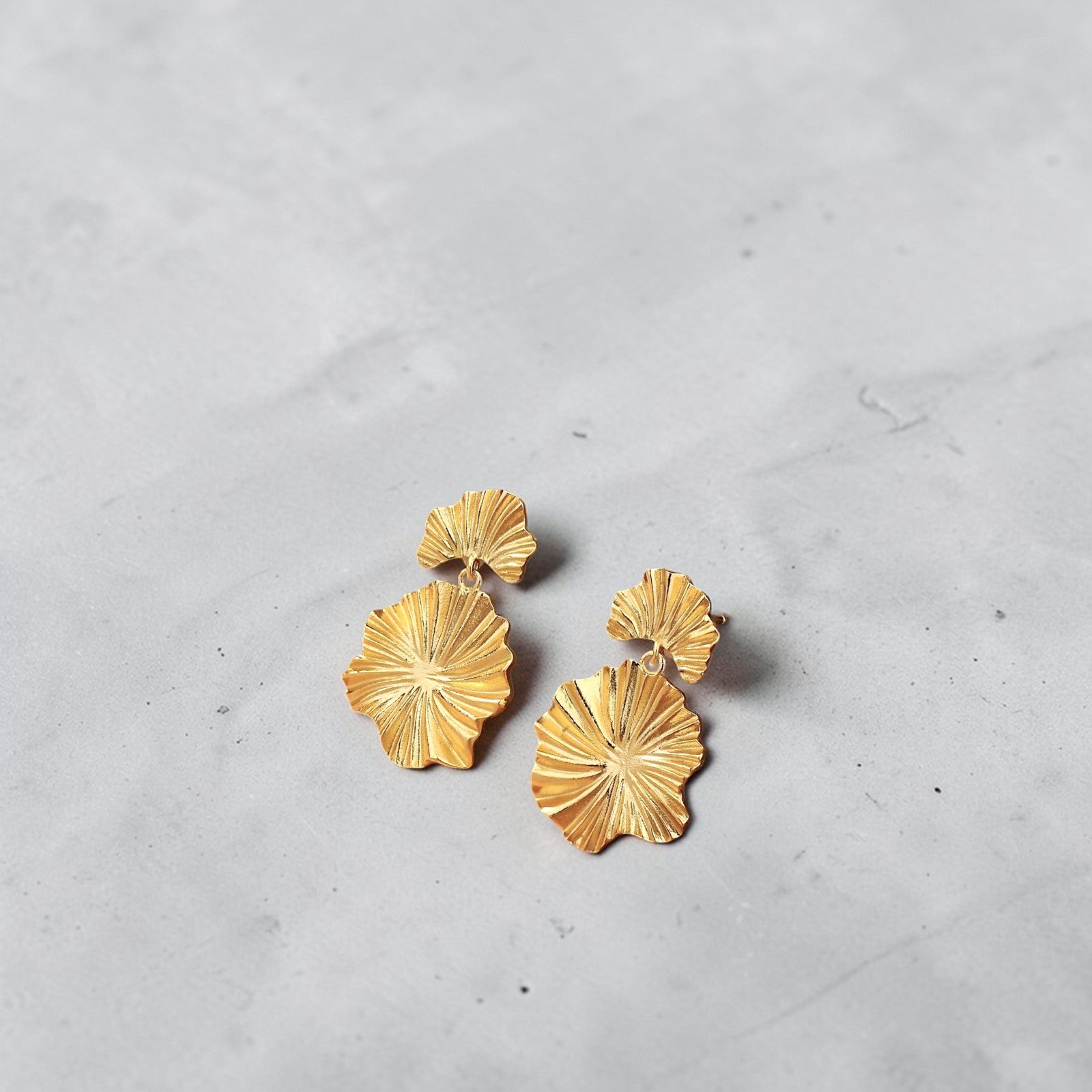 Amara Jewels gold-plated sterling silver leaf drop earrings with layered, textured design.