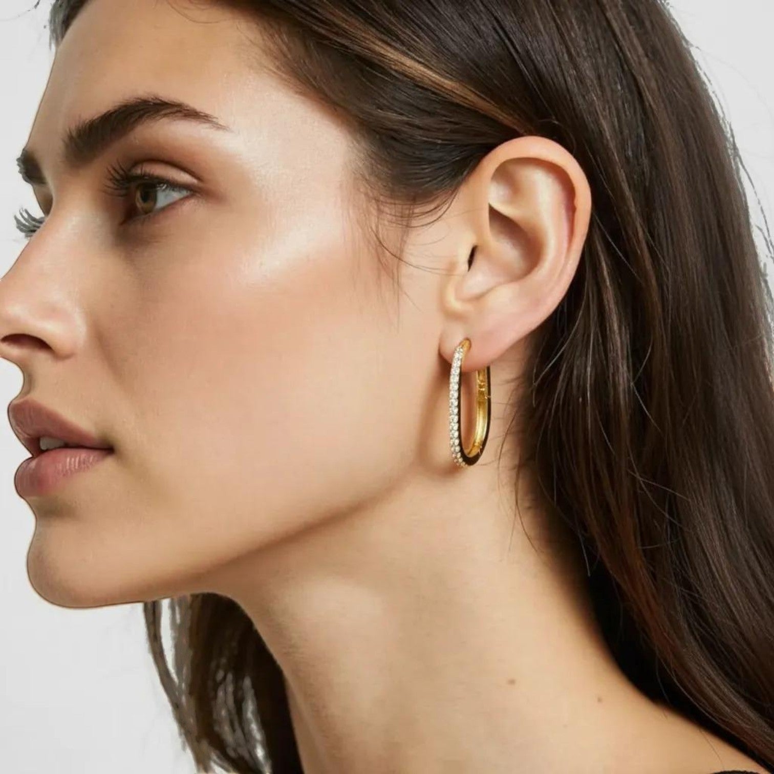 Amara Jewels gold-plated sterling silver oval hoop earrings with cubic zirconia accents.