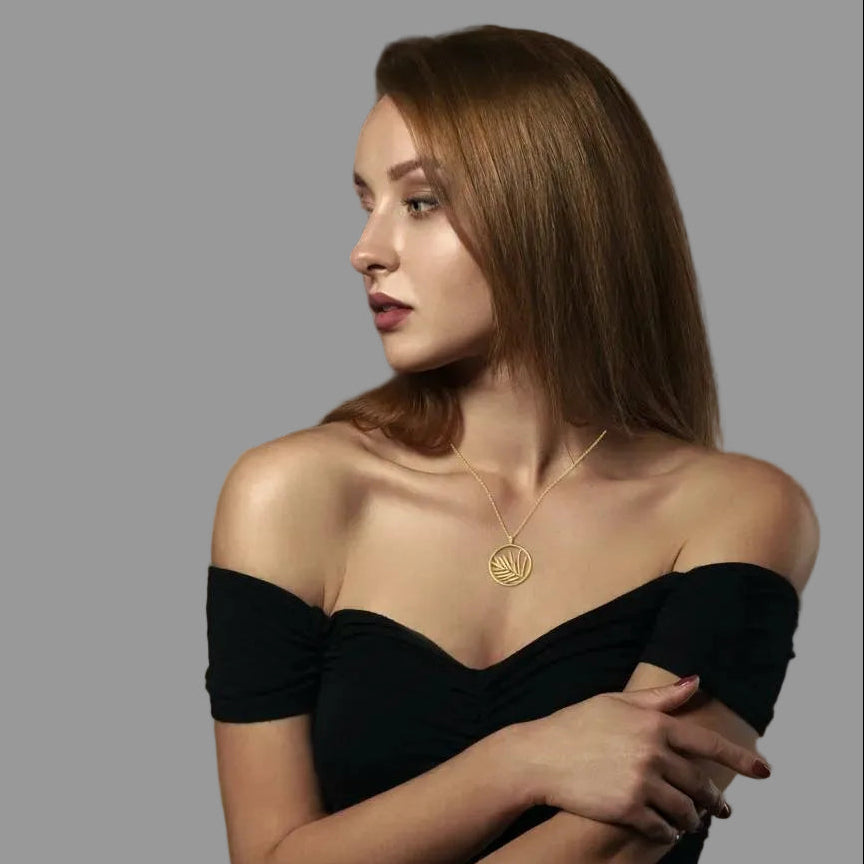 Amara Jewels gold plated sterling silver necklace with open circle palm leaf pendant.