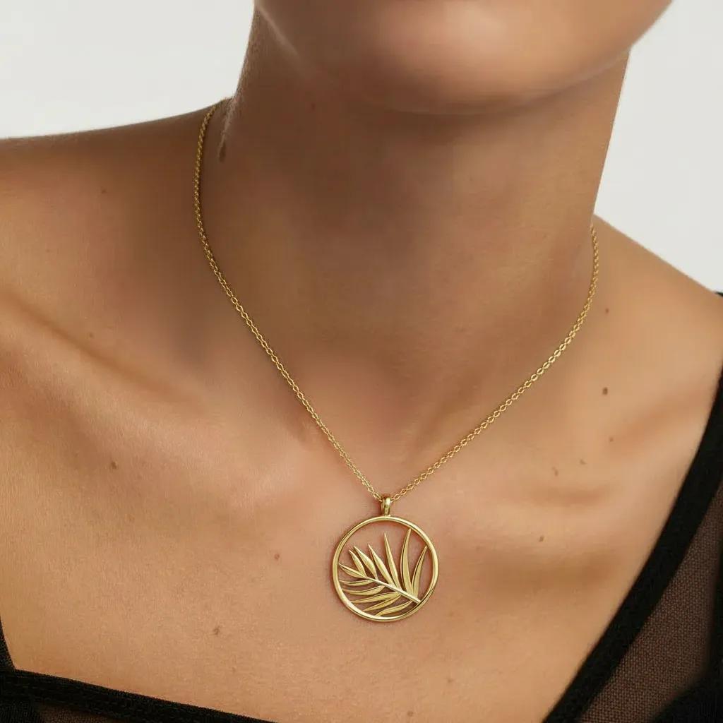 Amara Jewels gold plated sterling silver necklace with open circle palm leaf pendant.