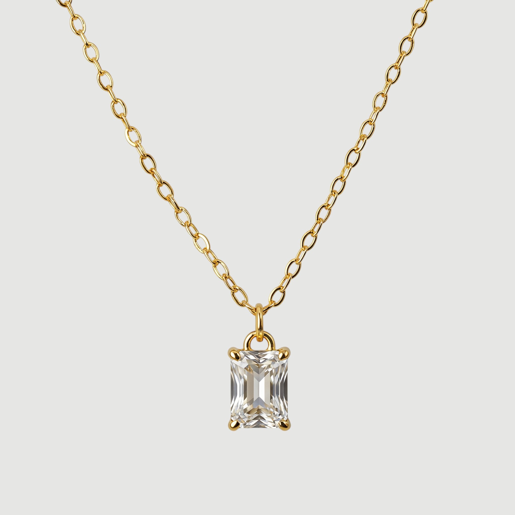 Amara Jewels gold-plated sterling silver necklace with a rectangular clear crystal pendant.