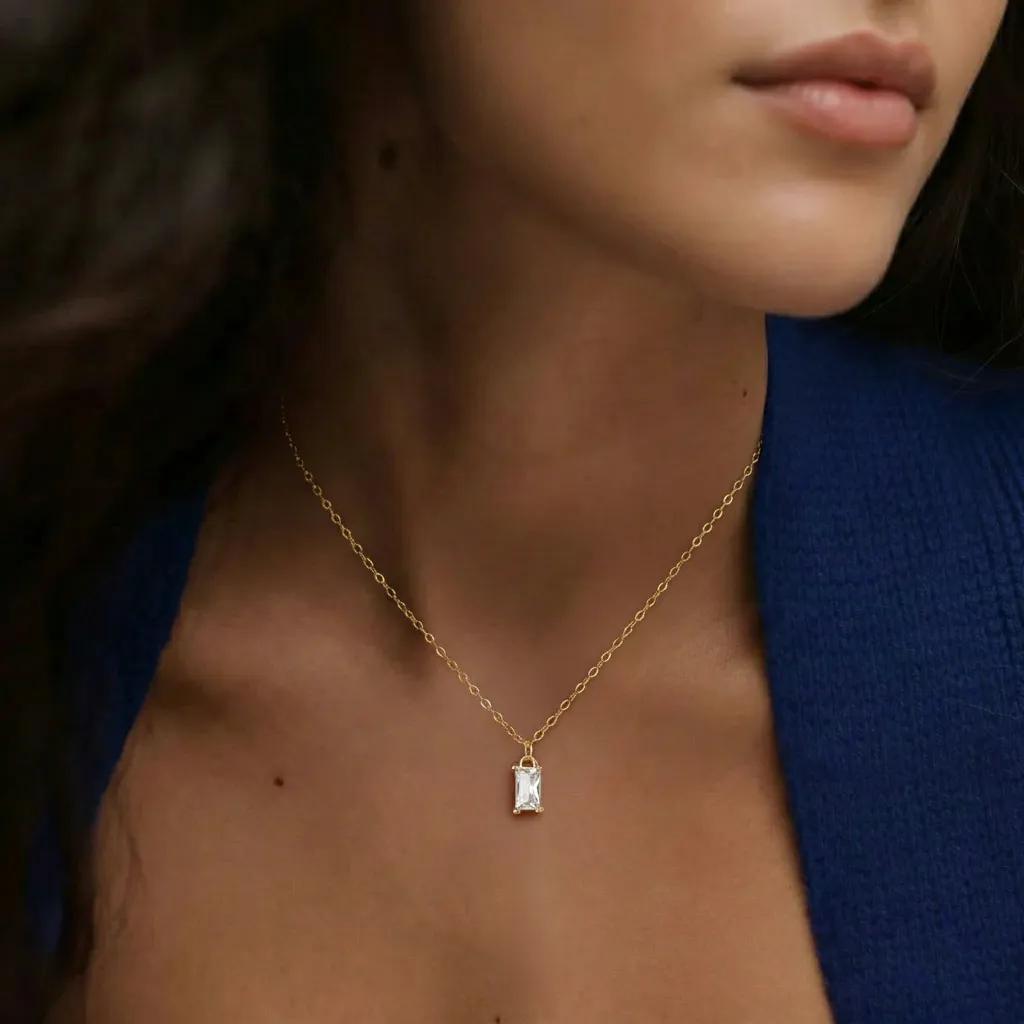 Amara Jewels gold-plated sterling silver necklace with a rectangular clear crystal pendant.