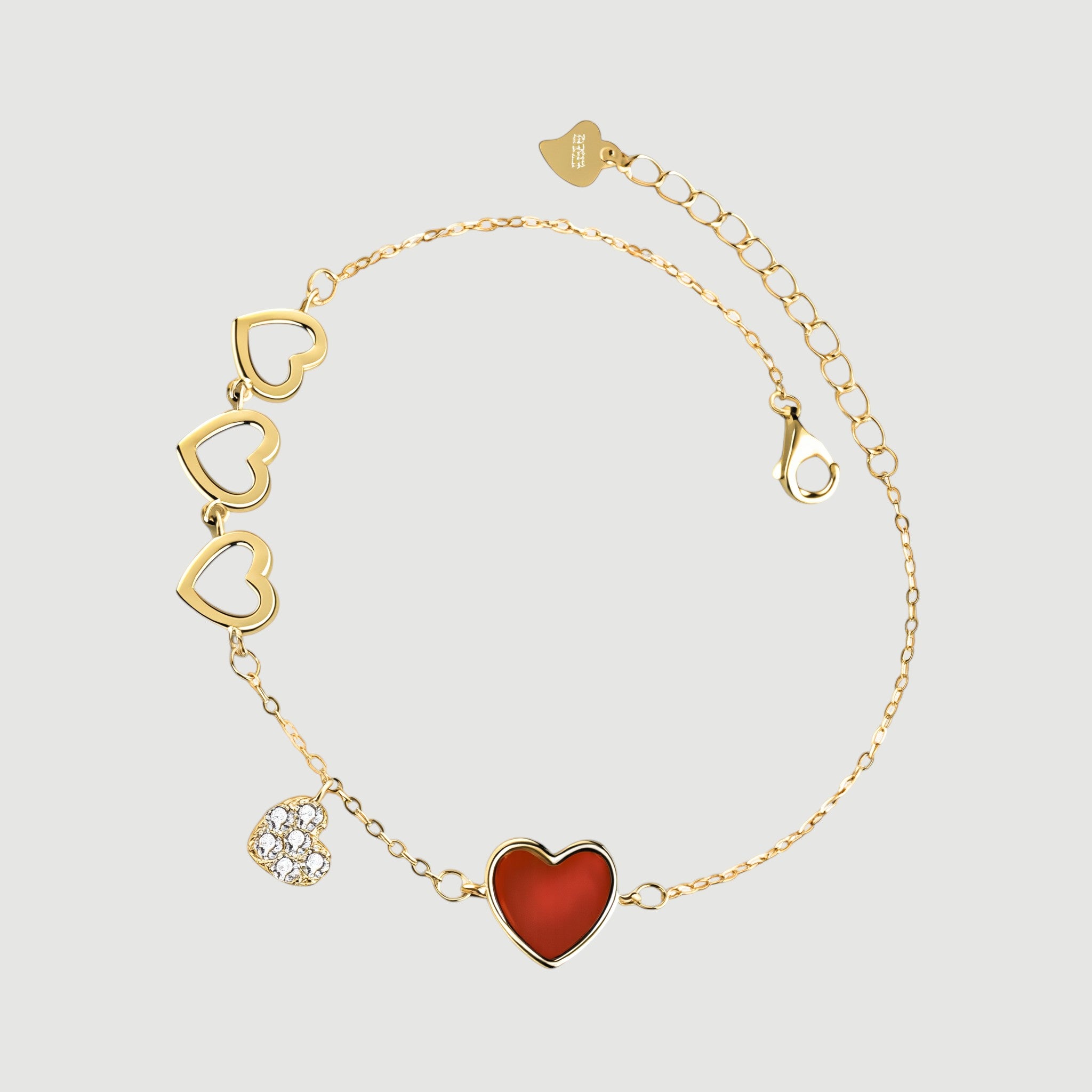 Amara Jewels gold-finished sterling silver bracelet with red enamel heart, cubic zirconia charm, and open hearts.