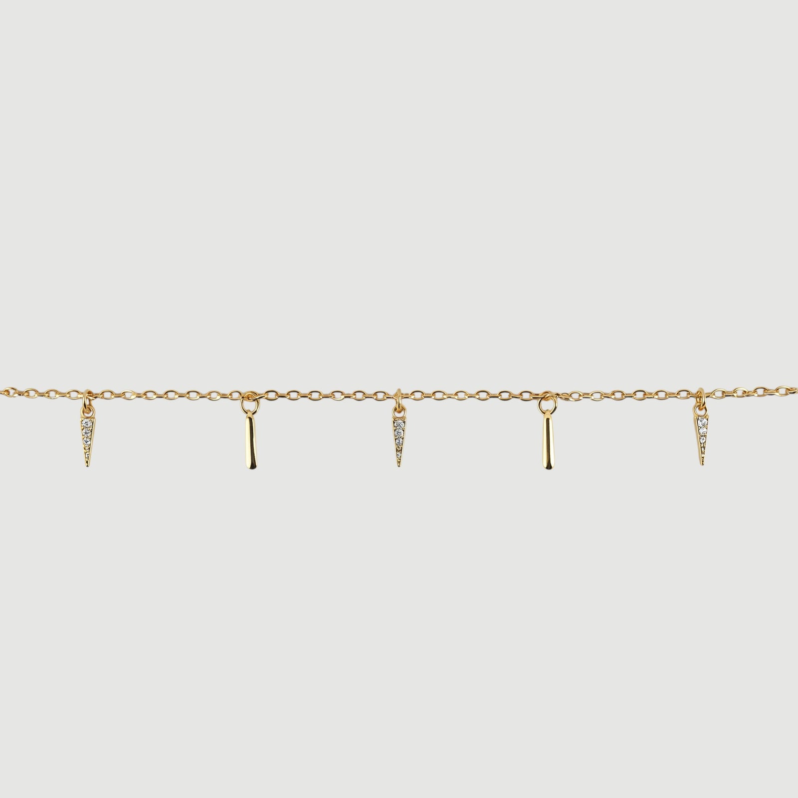 Amara Jewels gold-plated sterling silver necklace with dangling spike charms and small crystals.