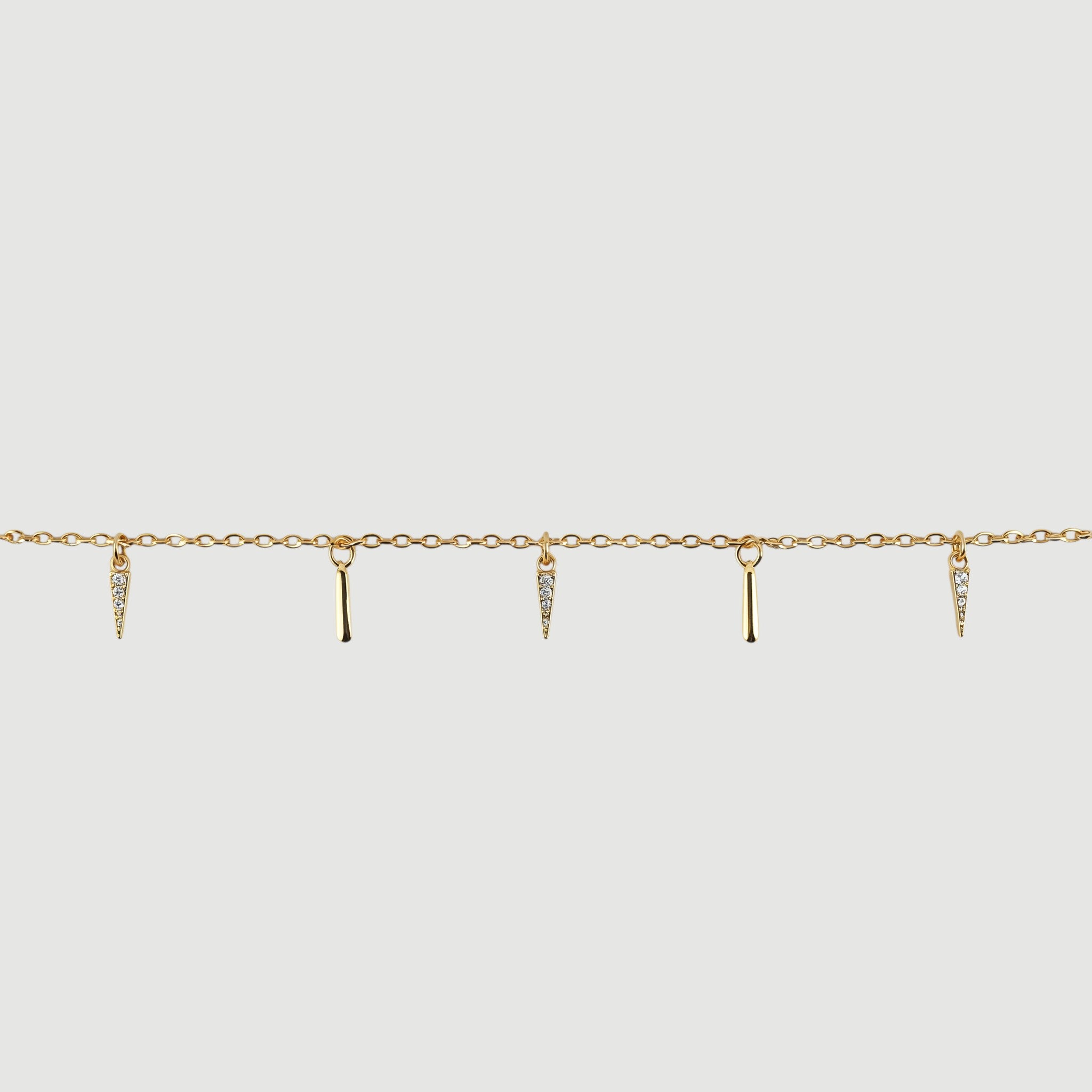 Amara Jewels gold-plated sterling silver necklace with dangling spike charms and small crystals.
