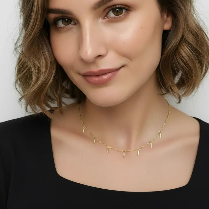 Amara Jewels gold-plated sterling silver necklace with dangling spike charms and small crystals.