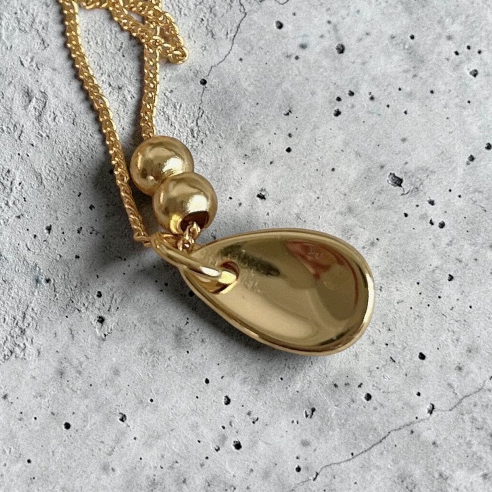 Amara Jewels 18K yellow gold polished sterling silver teardrop pendant necklace with two smooth beads on a delicate chain.