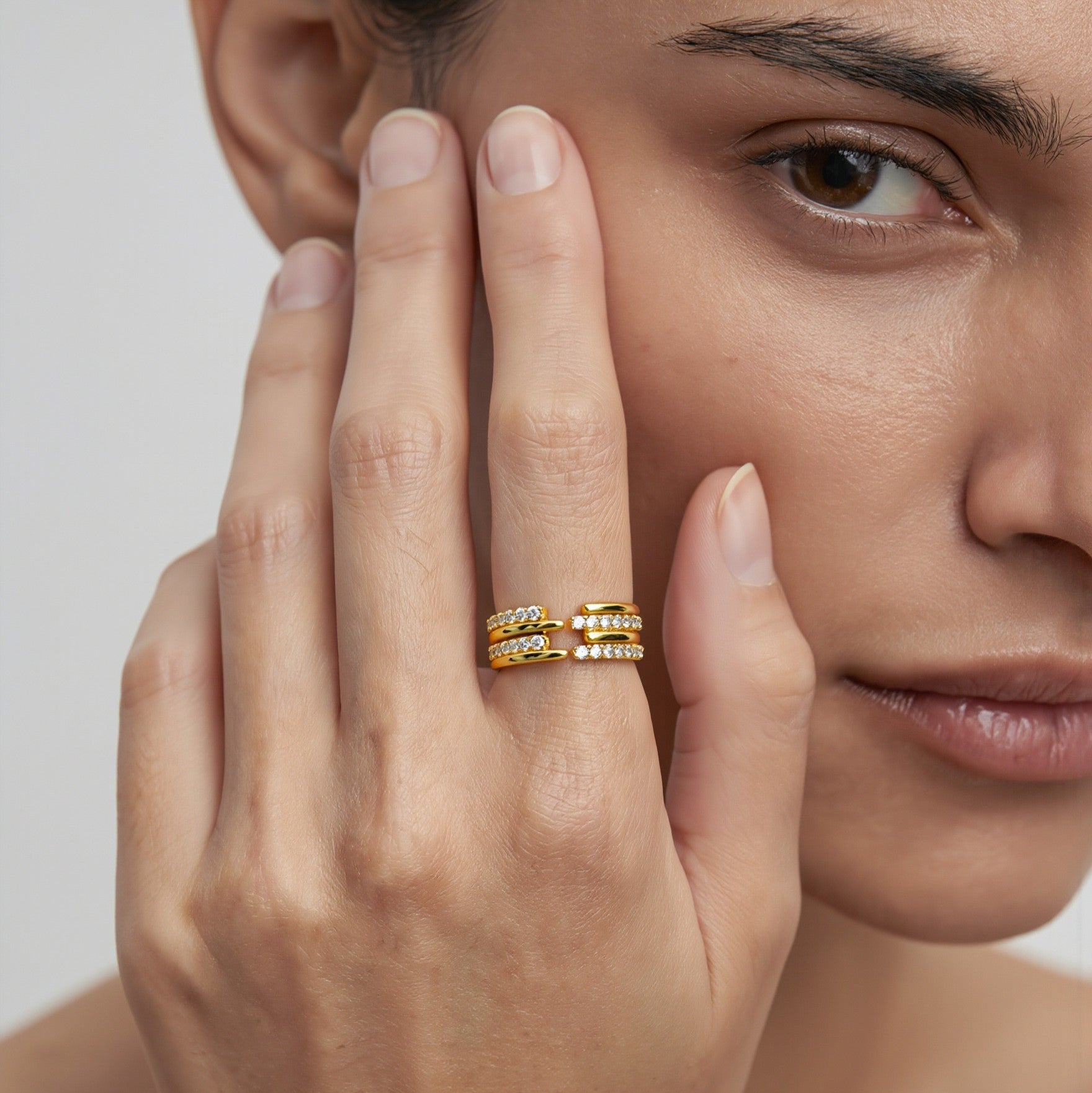 Amara Jewels gold-tone sterling silver open ring with three bands adorned with cubic zirconia.