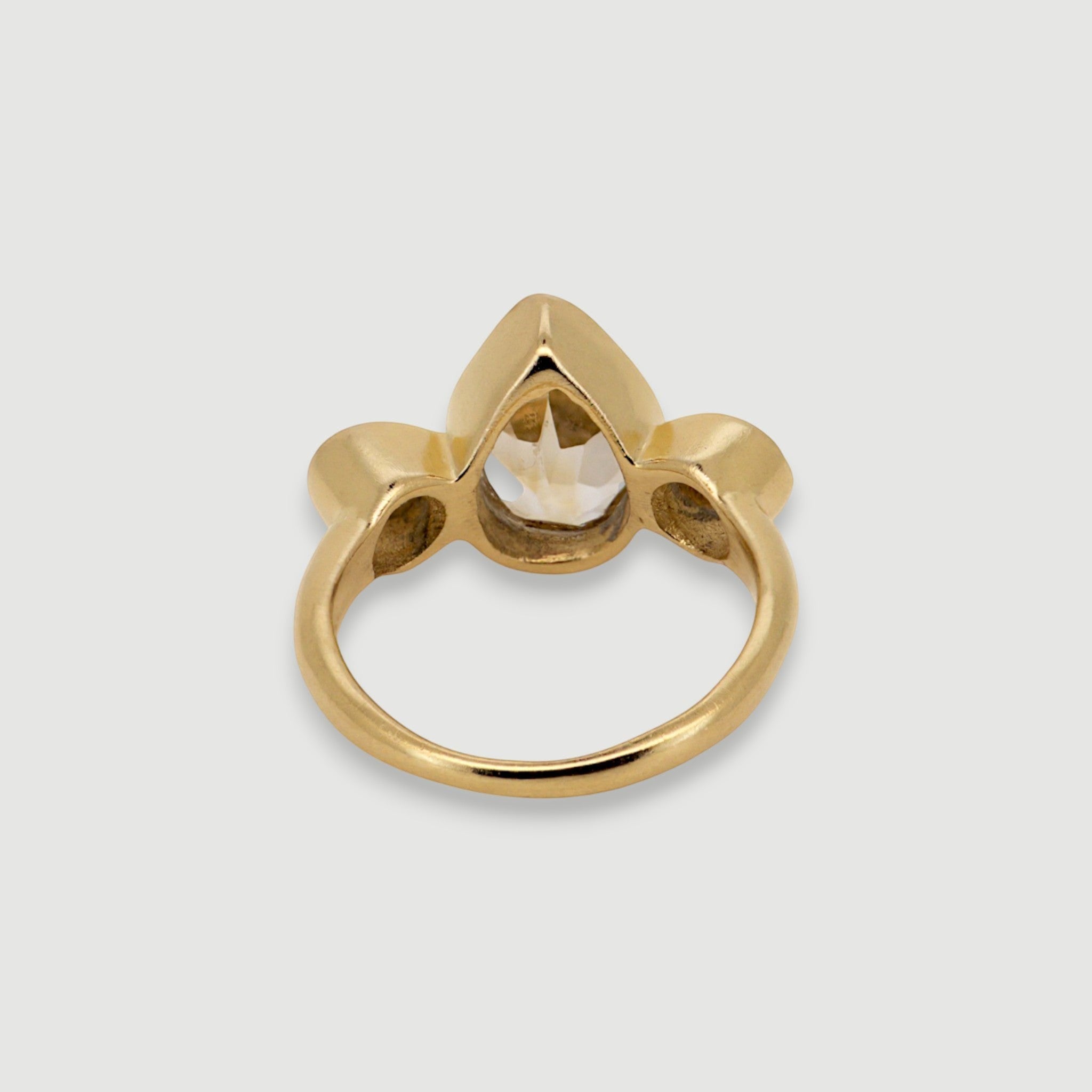 Amara Jewels elegant golden topaz ring with pear-shaped center stone and accent stones, 18K gold vermeil over 925 sterling silver.