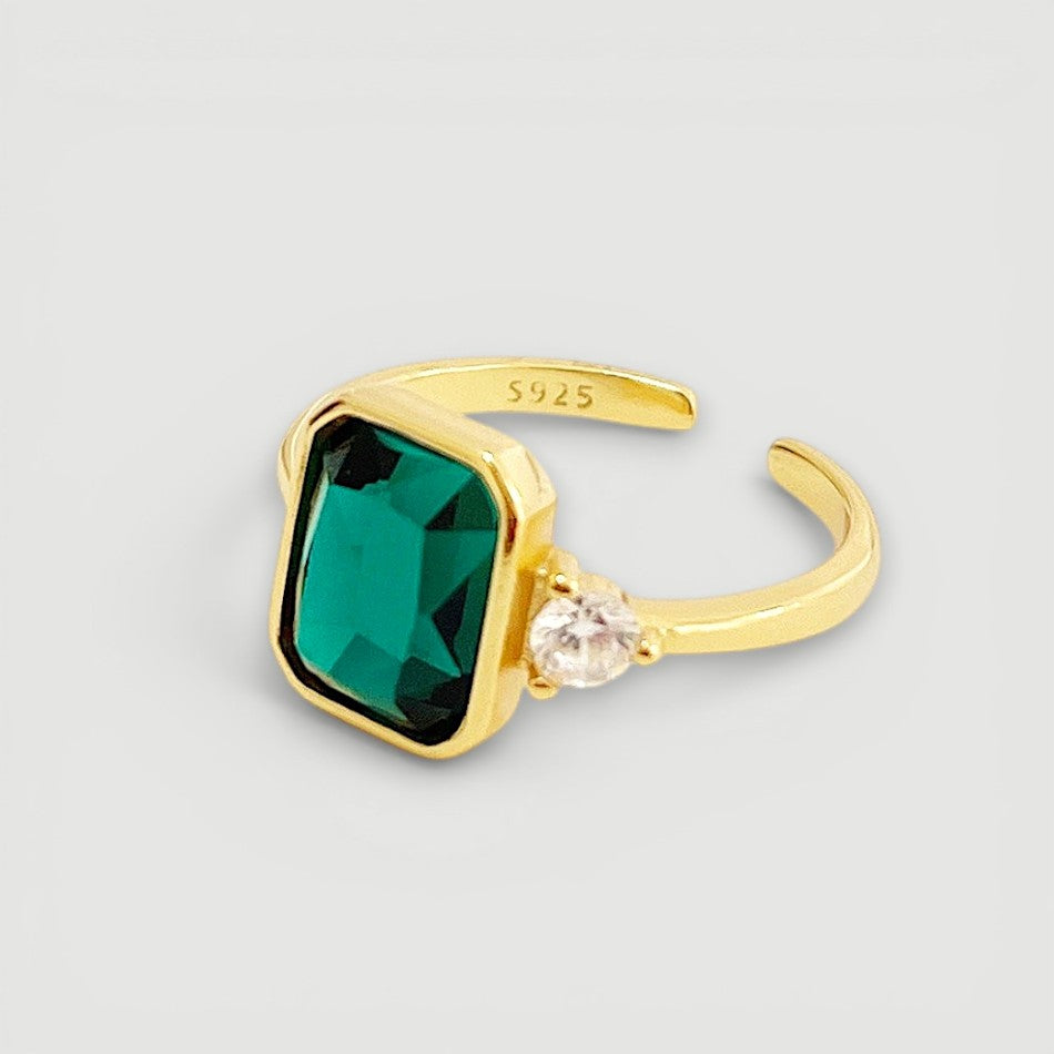 Amara Jewels gold-finish 925 sterling silver ring with rectangular emerald-green gemstone and cubic zirconia accent.