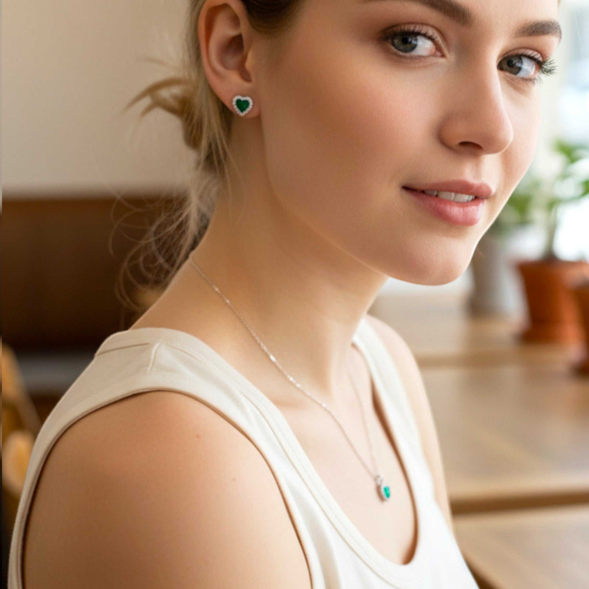 Amara Jewels green heart stud earrings with clear cubic zirconia halo, crafted from sterling silver.