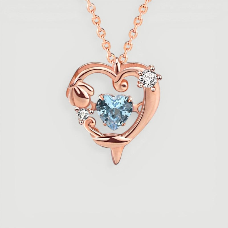 Amara Jewels rose gold plated sterling silver necklace with a heart-shaped aquamarine pendant and crystal accents.