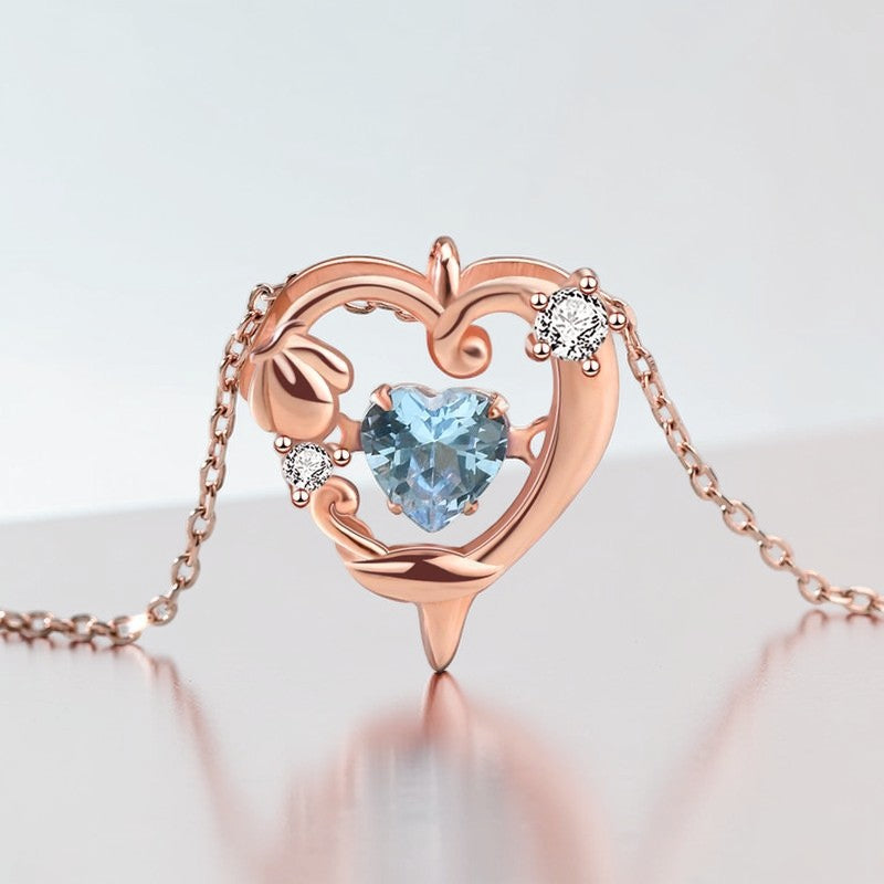 Amara Jewels rose gold plated sterling silver necklace with a heart-shaped aquamarine pendant and crystal accents.