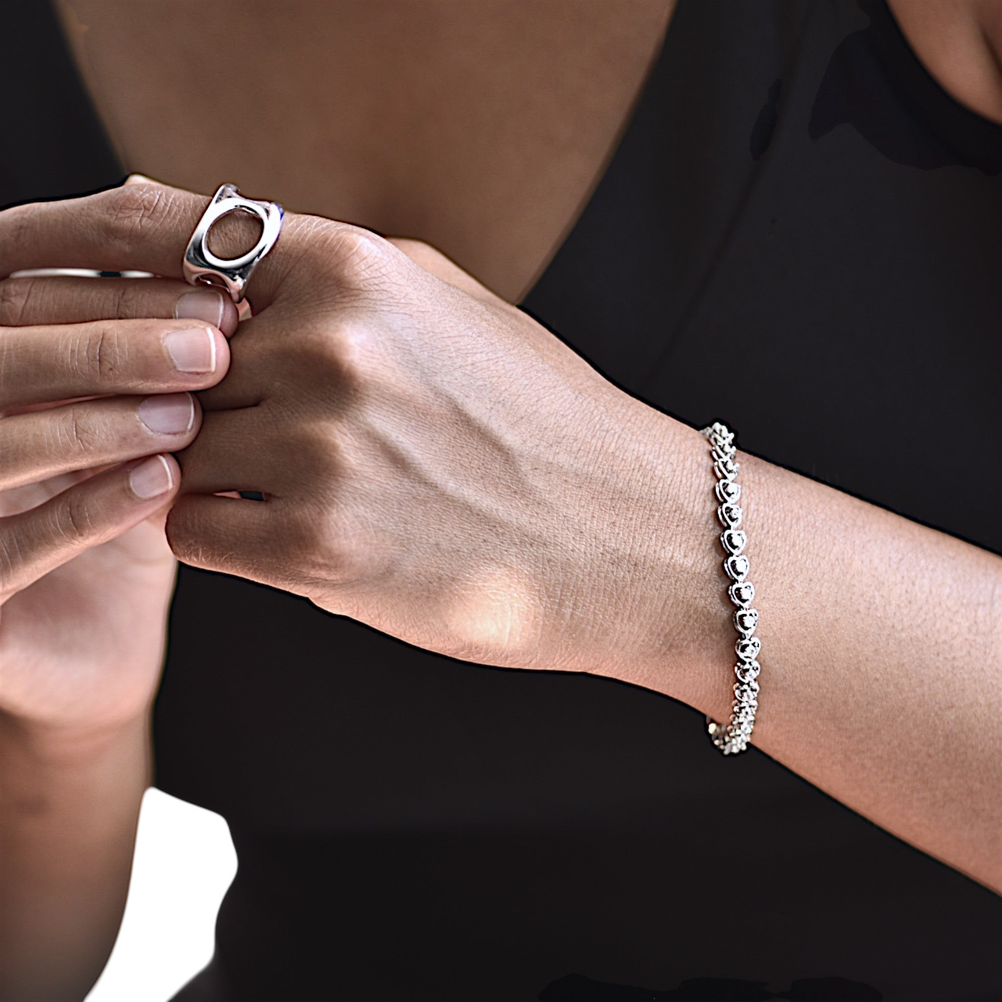 Amara Jewels 925 sterling silver bracelet with delicate heart-shaped links and cubic zirconia accents, secured with a lobster clasp.