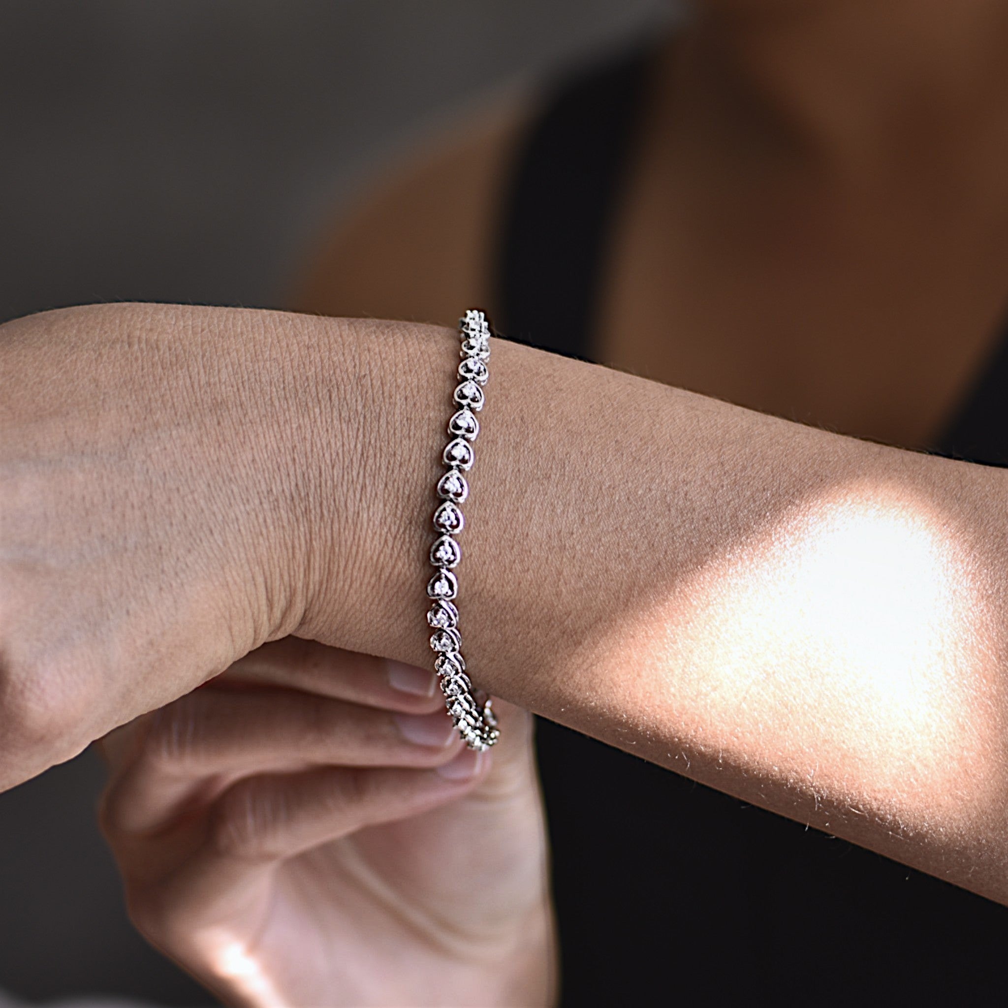 Amara Jewels 925 sterling silver bracelet with delicate heart-shaped links and cubic zirconia accents, secured with a lobster clasp.