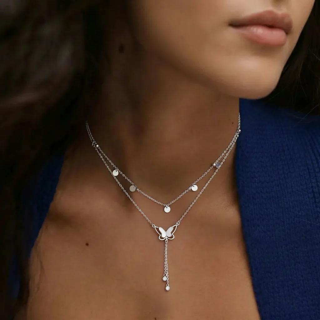 Amara Jewels double-layered sterling silver necklace with butterfly pendant and dangling crystals.