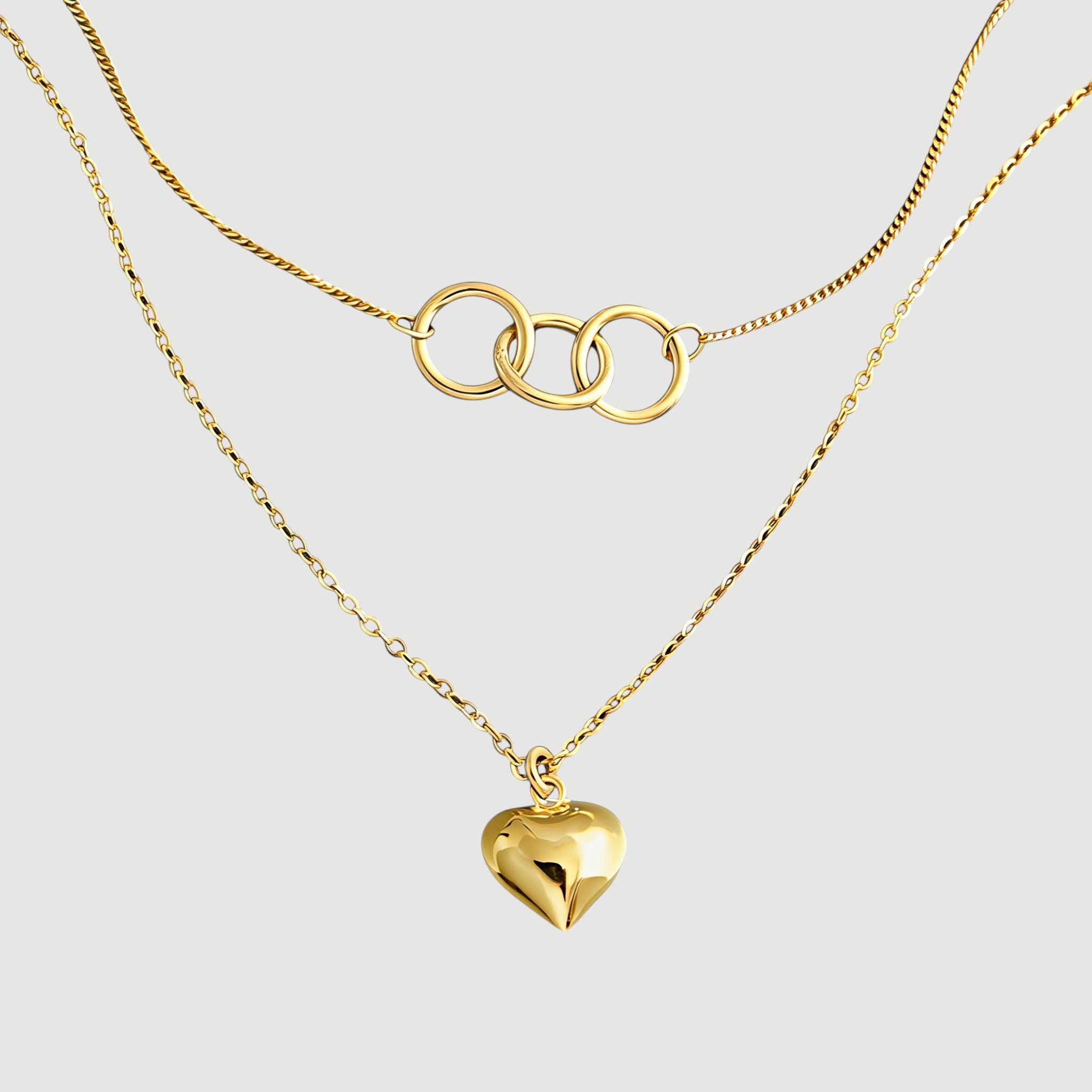 Amara Jewels gold-plated sterling silver layered necklace with heart and interlocking circles pendants.