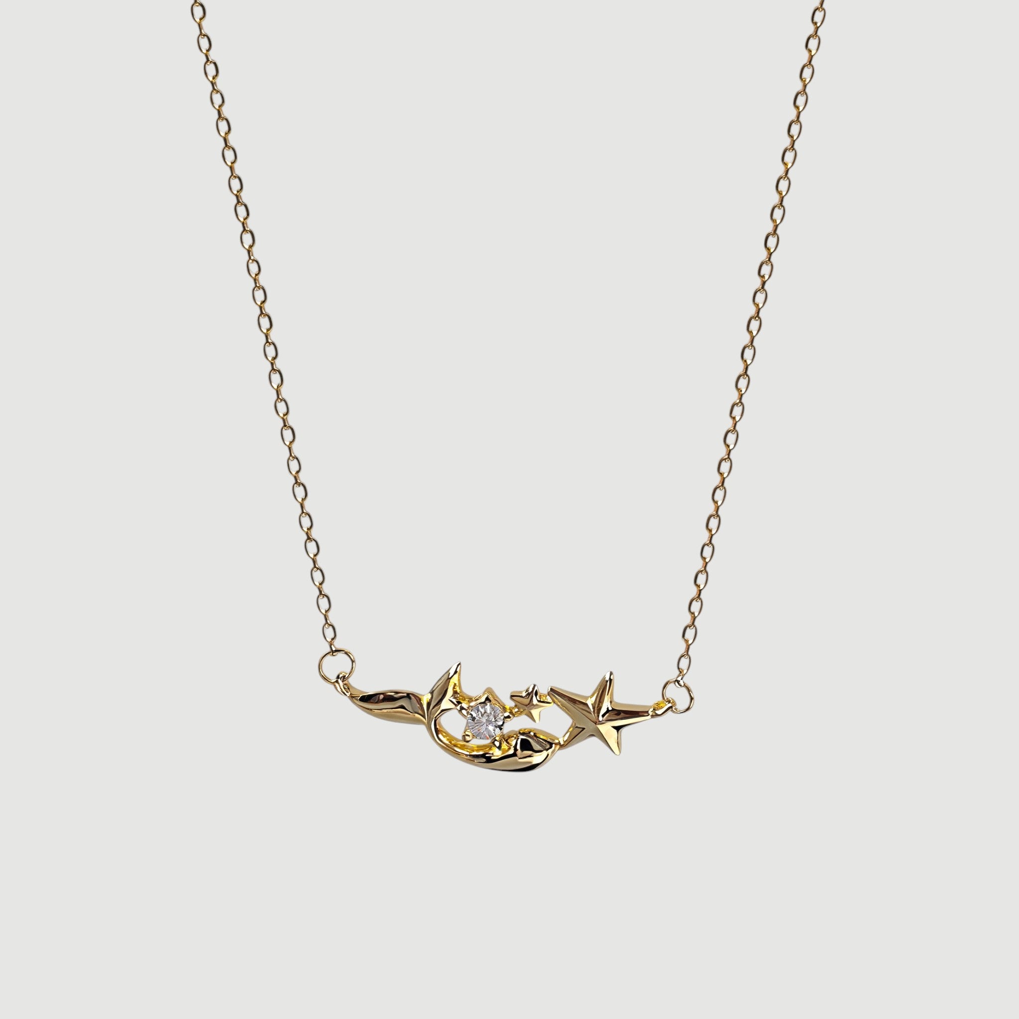 Amara Jewels gold plated sterling silver mermaid and star necklace with crystal accent.