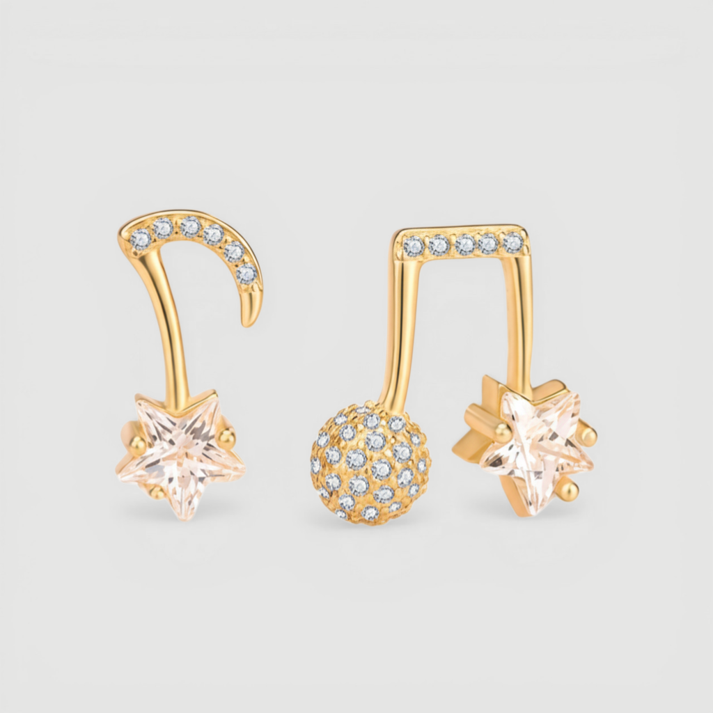 Amara Jewels gold-plated sterling silver asymmetrical music note and star earrings with cubic zirconia.